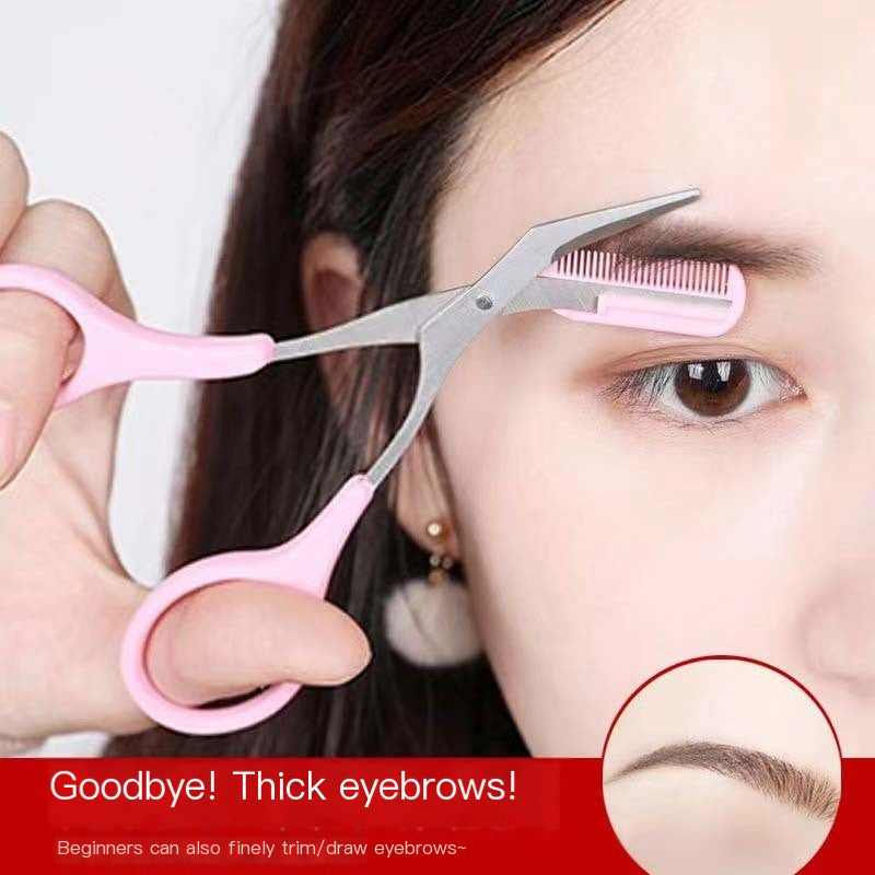 Person using pink-handled stainless steel eyebrow trimming scissors with an attached grooming comb on their brow.