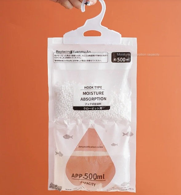 Clear hanging closet dehumidifier bag with white absorbent beads and 500ml capacity indicator against orange background.