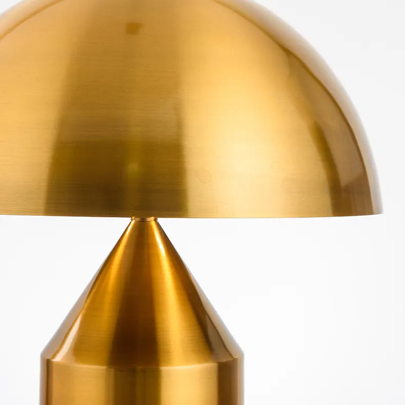Mid-century modern mushroom desk lamp with a brushed copper metallic finish and smooth, minimalist dome silhouette.