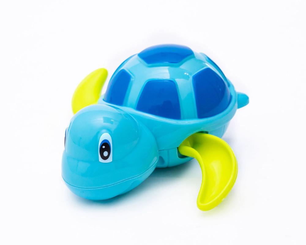 Blue plastic wind-up turtle toy with lime green flippers and a blue and light blue patterned shell.