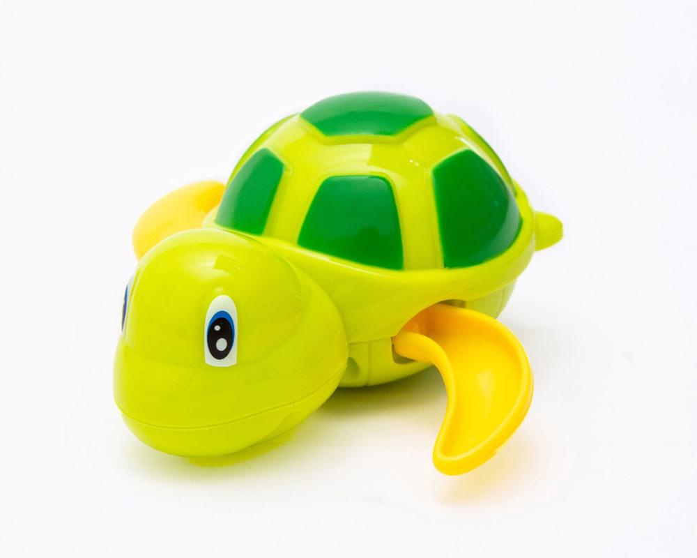 Bright lime green and yellow turtle wind-up toy with a dark green shell pattern and blue-eyed cartoon face.