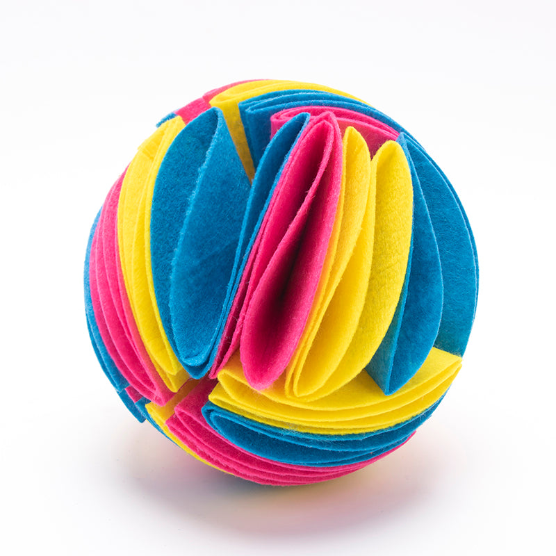 Interactive dog snuffle ball made of layered, felt-like fabric in vibrant pink, blue, and yellow petals.