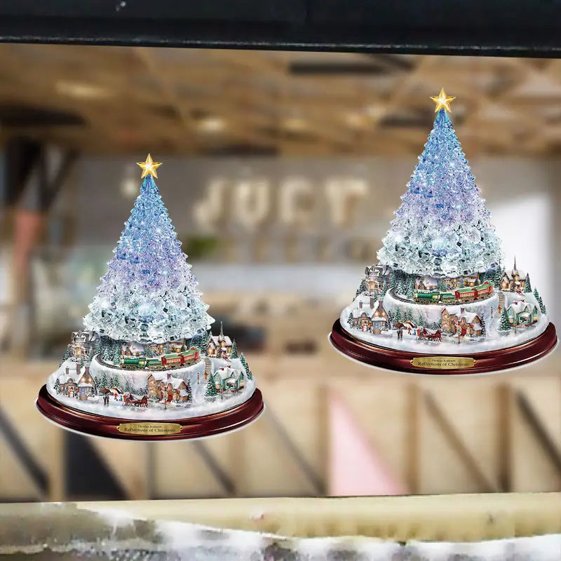 Two illuminated, crystalline Christmas tree figurines featuring miniature snowy villages and trains on wooden bases.